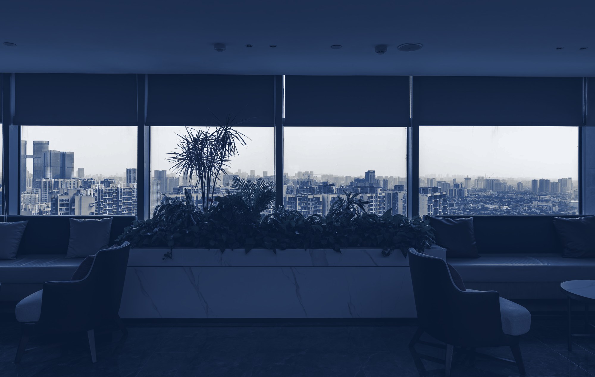 Resident lounge with a city view, tinted navy