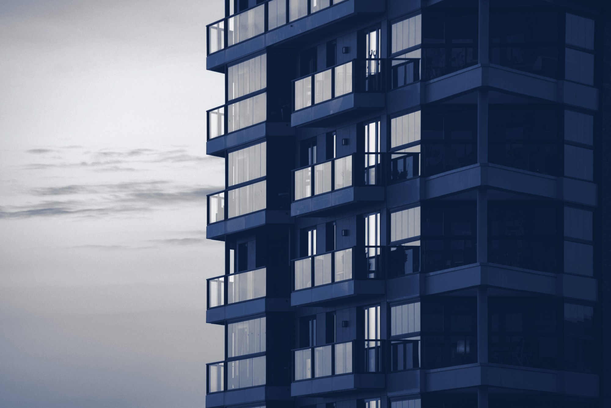 Apartment tower with balconies, tinted navy