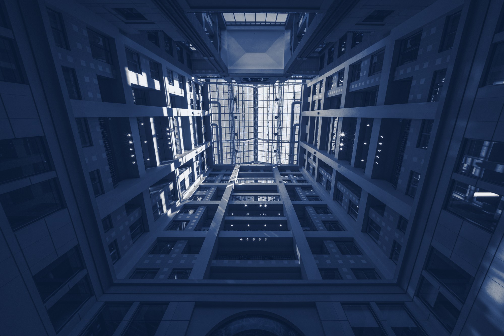 Office atrium seen from below, tinted navy